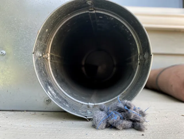 Clinton Dryer Vent Cleaning technician using specialized equipment to clear severe dryer vent blockage in Clinton